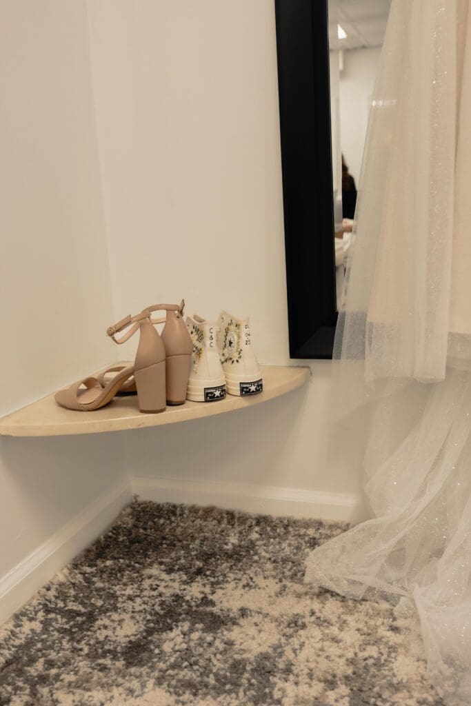 The brides 2 shoes for her wedding day including one pair of heels and 1 pair of custom chuck taylors