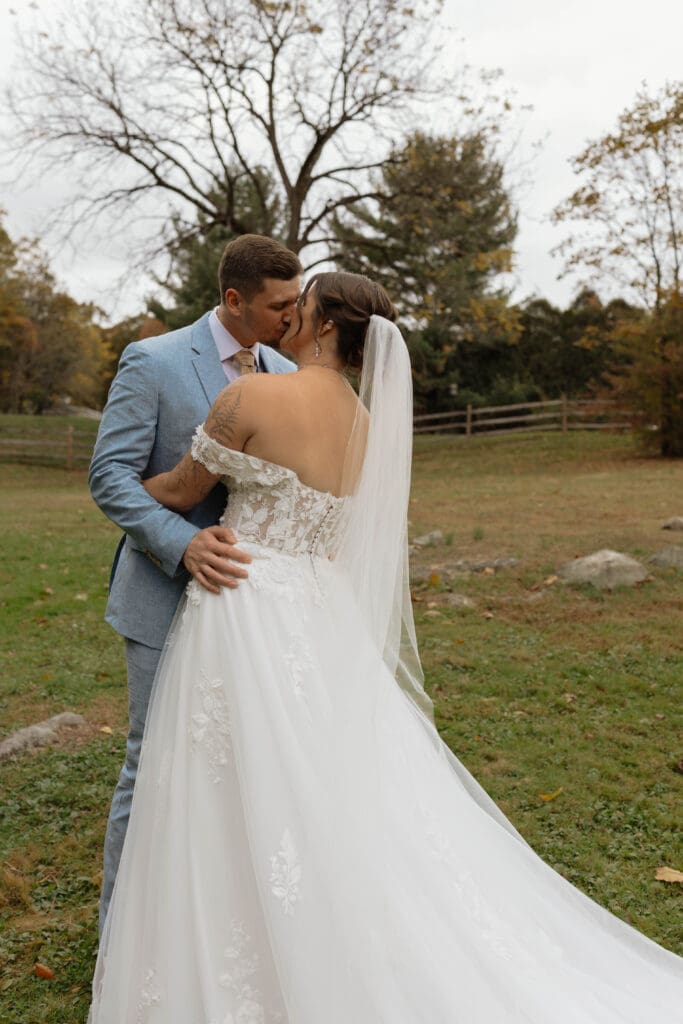A soon to married couple the moment after their first look sharing a kiss