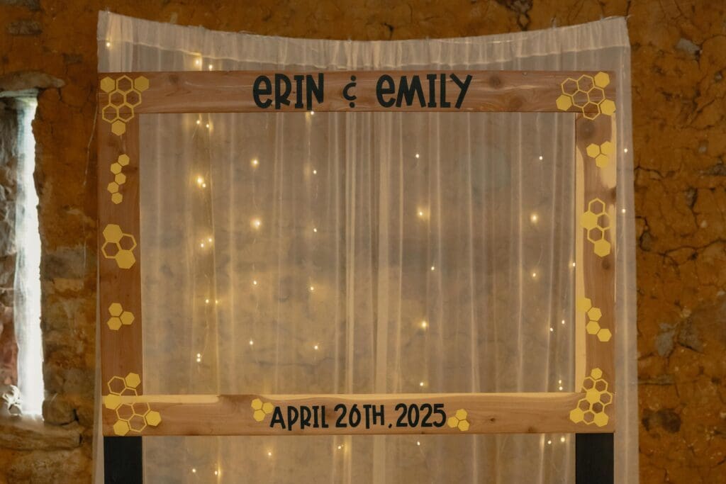 A life size picture frame at a wedding for guests to pose with for Emily & Erin